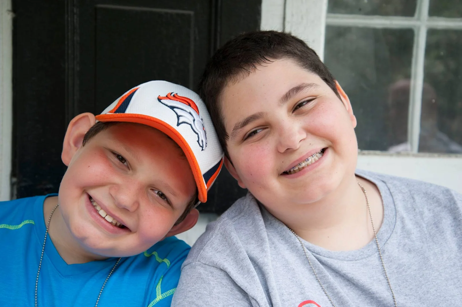 Two smiling boys at Hands Holding Hearts camp