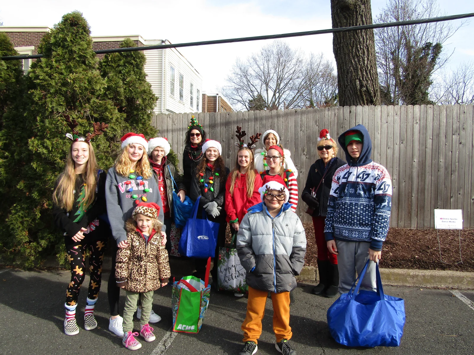 Volunteers in Santa hats delivering gift bags during a community outreach