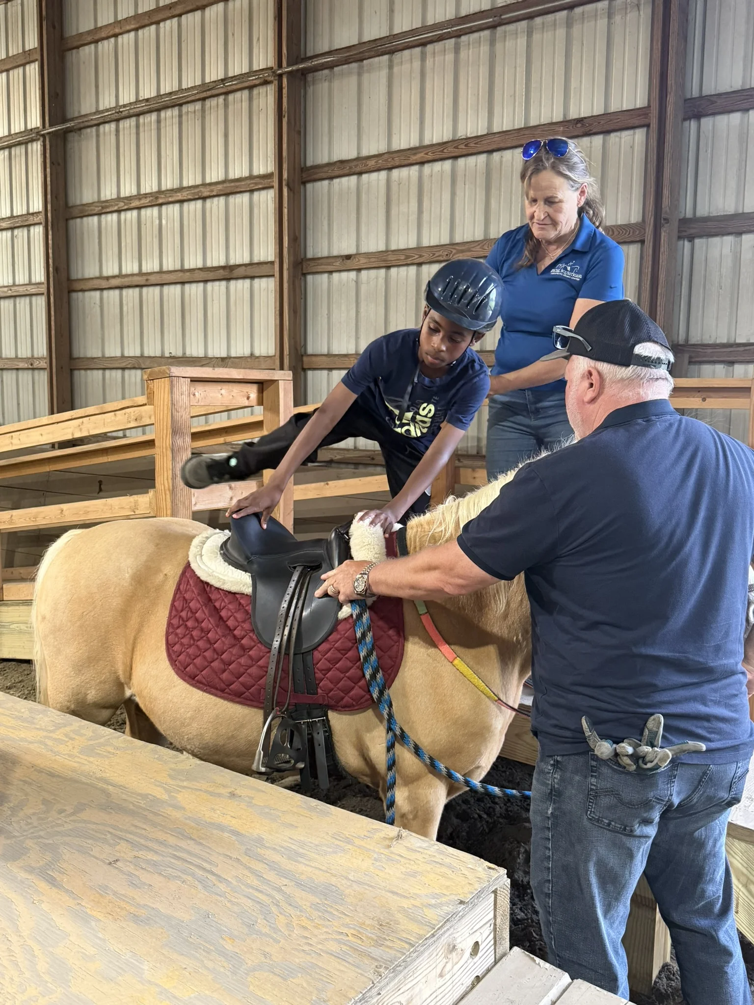 A Hands Holding Hearts family spending time with the therapy horses at Special Equestrians