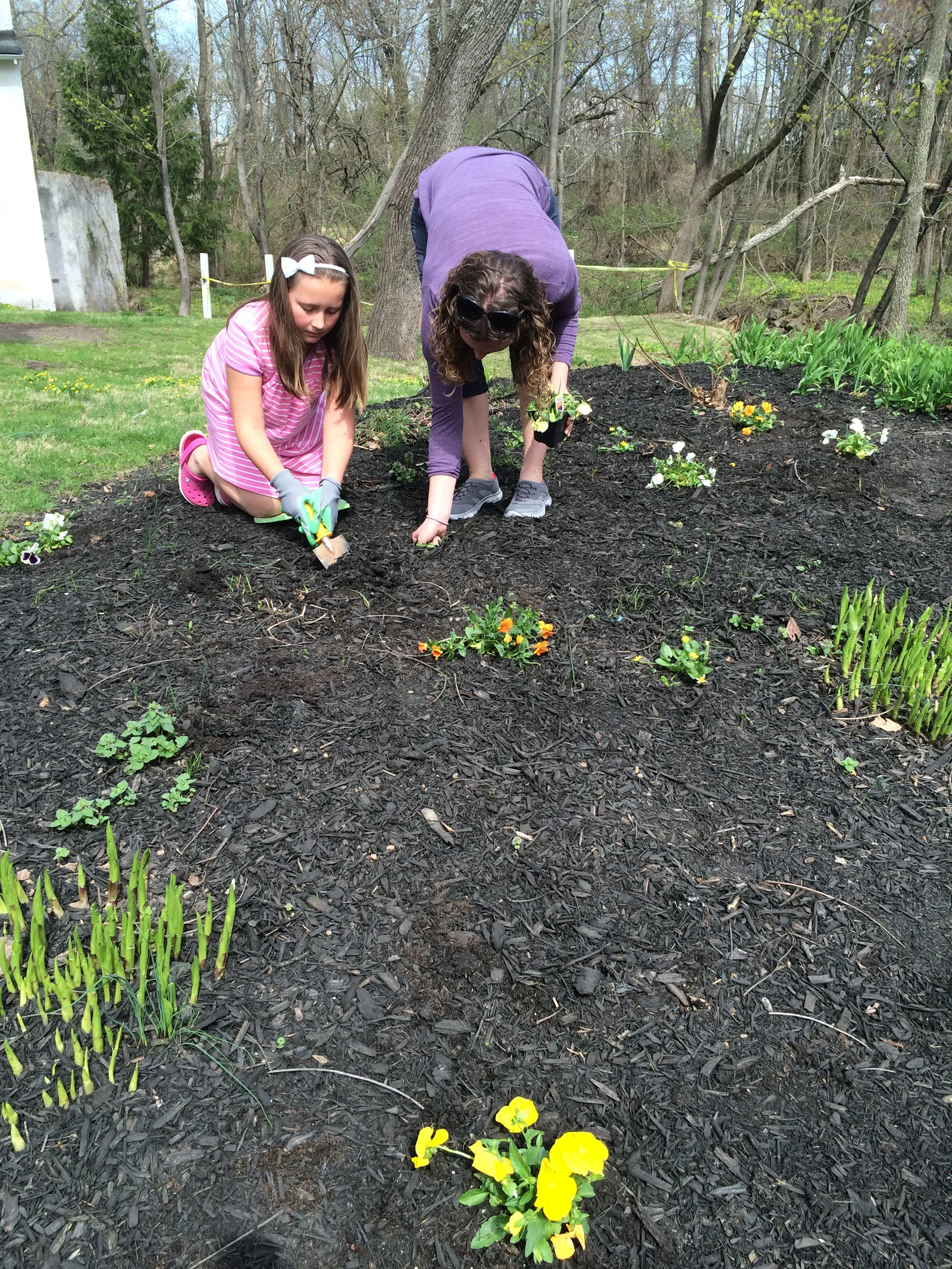 Children planting in a garden during a camp activity