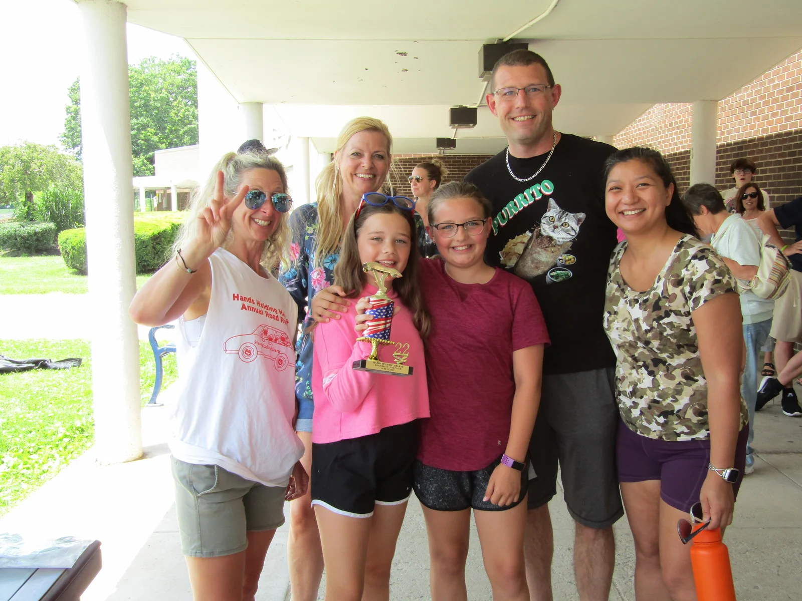 Campers and volunteers in tie-dye shirts gathered together outdoors