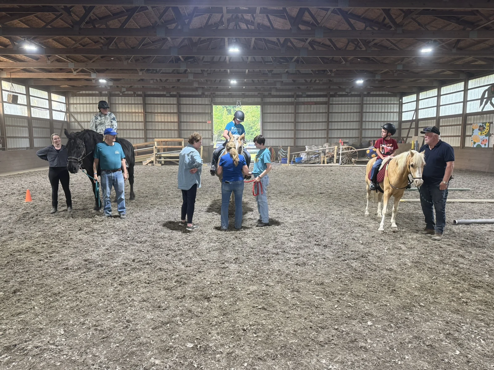 A Hands Holding Hearts family spending time with the therapy horses at Special Equestrians